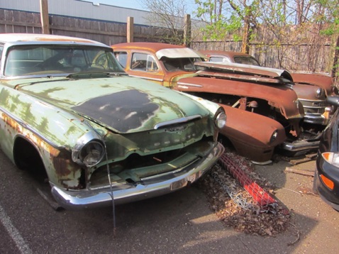 Old DeSoto and two Chryslers in corner of lot - waiting for the salvage man