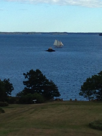 Sailing ship passing by the tiny island Sailing ship passing by the tiny island